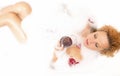 Spa Concepts. Sensual Alluring Caucasian Blond Female in Foamy Bathtub