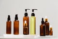 Spa cosmetics in brown glass bottles on gray concrete table. Copy space for text. Beauty blogger, salon therapy, branding mockup,