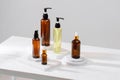 Spa cosmetics in brown glass bottles on gray concrete table. Copy space for text. Beauty blogger, salon therapy, branding mockup, Royalty Free Stock Photo