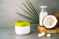 Spa cream for body skincare and hair with coconut oil, fresh coconuts, palm leaf and bottle with coconut butter on dark Royalty Free Stock Photo