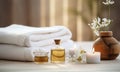 Spa decoration with candle, daisies , white flowers and a bottle with massage oil.