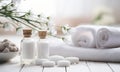 Spa decoration with candle, daisies , white flowers and a bottle with massage oil.