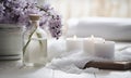 Spa decoration with sea salts, candle, flower and a bottle with massage oil.