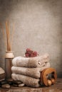 Spa essentials, aroma sticks, stones, towels, sea shell on a wooden rustic background
