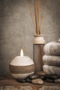 Spa essentials, aroma sticks, stones, towels, sea shell on a wooden rustic background