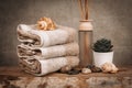 Spa essentials, aroma sticks, stones, towels, sea shell on a wooden rustic background Royalty Free Stock Photo