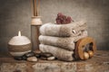 Spa essentials, aroma sticks, stones, towels, sea shell on a wooden rustic background