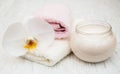 Spa essentials cream white towels and orchids Royalty Free Stock Photo