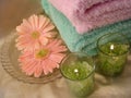 Spa essentials (green candles and towels with flowers) Royalty Free Stock Photo