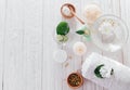 Spa essentials including candle, salt, herbs and white clay