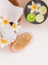 Rolled towels, candles and frangipani flowers, top view Royalty Free Stock Photo