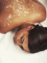 Spa, exfoliate and massage for woman, salt and relax with peace, luxury and calm in bed of resort. Wellness, comfort and