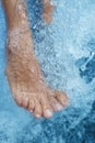 Spa - Female leg massage with aerated blue water