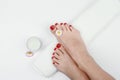 Spa and foot care concept. Women`s legs with a white rolled towel