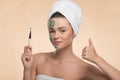 Spa girl with a towel on her head applying facial Royalty Free Stock Photo