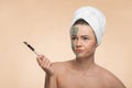 Spa girl with a towel on her head applying facial Royalty Free Stock Photo