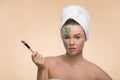 Spa girl with a towel on her head applying facial Royalty Free Stock Photo