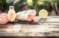 Spa handmade soap with white towels and sea salt, the composition of the tropical leaves with a candle, wooden background Royalty Free Stock Photo