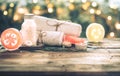 Spa handmade soap with white towels and sea salt, the composition of the tropical leaves with a candle, wooden background Royalty Free Stock Photo