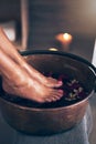 Spa, health and woman feet in water to soak with flowers for a luxury, glamour and pedicure treatment. Wellness, beauty Royalty Free Stock Photo