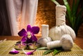 Spa herbal compressing ball with candles and orchid Royalty Free Stock Photo