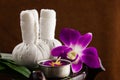 Spa herbal compressing ball with candles and orchid Royalty Free Stock Photo