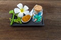 Spa herbal white frangipani flowers, turmeric powder in white spoon ,pill,Cissus Quadrangularis Linn on wooden background Royalty Free Stock Photo