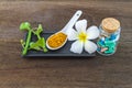 Spa herbal white frangipani flowers, turmeric powder in white spoon ,pill,Cissus Quadrangularis Linn on wooden background Royalty Free Stock Photo
