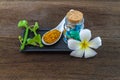 Spa herbal white frangipani flowers, turmeric powder in white spoon ,pill,Cissus Quadrangularis Linn on wooden background Royalty Free Stock Photo