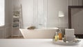 Spa, hotel bathroom concept. White table top or shelf with bathing accessories, toiletries, over blurred scandinavian bathroom, mo Royalty Free Stock Photo