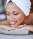 The spa makes her happy. a young woman lying on a massage table. Royalty Free Stock Photo