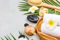 Spa massage Aromatherapy body care background. Spa cosmetics, towel and tropical leaves on gray concrete table. copy space. Beauty Royalty Free Stock Photo