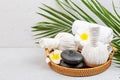 Spa massage Aromatherapy body care background. Spa herbal bags, towel and tropical flowers on gray concrete table. copy Royalty Free Stock Photo