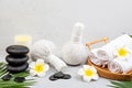 Spa massage Aromatherapy body care background. Spa herbal bags, towel and tropical flowers on gray concrete table. copy space. Royalty Free Stock Photo