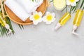 Spa massage Aromatherapy body care background. Spa herbal balls, cosmetics, towel and tropical leaves on gray concrete table. Top Royalty Free Stock Photo