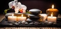 Spa Massage basalt stones with candles, lotus flowers, orchid flower and towels on bamboo mat. Generative AI Royalty Free Stock Photo