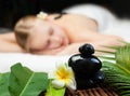 Spa massage. Beautiful young woman getting spa massage. Focus on Spa objects Royalty Free Stock Photo