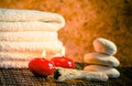 Spa massage border background with towel stacked stone and red candles warm atmosphere Royalty Free Stock Photo