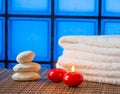 Spa massage border background with towel stacked stone and red candles warm atmosphere Royalty Free Stock Photo