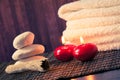 Spa massage border background with towel stacked stone and red candles warm atmosphere Royalty Free Stock Photo