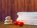 Spa massage border background with towel stacked stone and red candles warm atmosphere Royalty Free Stock Photo