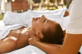 Spa Massage. Happy Woman Enjoying Relaxing Neck Body Massage. Royalty Free Stock Photo