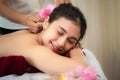 Spa Massage.  Masseur doing massage with treatment sugar scrub on Asian woman body in the Thai spa lifestyle, so relax and luxury. Royalty Free Stock Photo