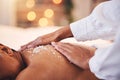 Spa, massage and salt on back for detox, exfoliate and skin care with hand of therapist for luxury treatment for health