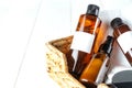 SPA natural organic cosmetics for personal hygiene. Amber unbranded cosmetic bottles, in wooden basket in bathroom