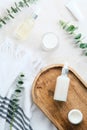 SPA natural organic cosmetics set with eucalyptus branches on stone table in bathroom. Flat lay, top view Royalty Free Stock Photo