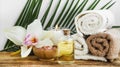 Spa orchid setting with towels, body oil, candle and salt Royalty Free Stock Photo