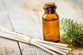 Spa with organic spruce oil in glass bottles on woden table background