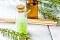 spa with organic spruce oil and sea salt in glass bottles on whi