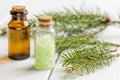 Spa with organic spruce oil and sea salt in glass bottles on white table background Royalty Free Stock Photo